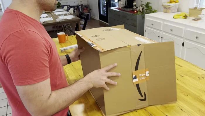 Cut the tape and lay the box flat.