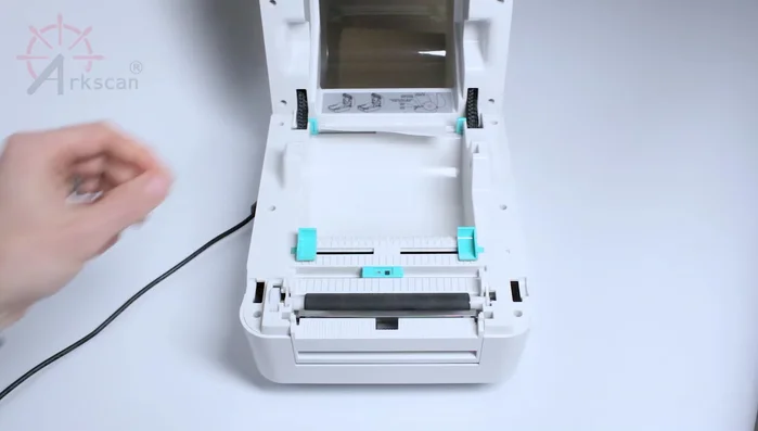 Pull the label through the slot from the front.