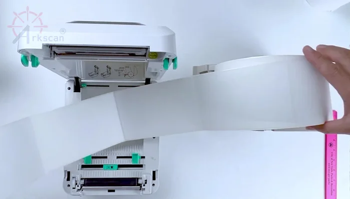 Load the labels through the back of the printer as shown previously.