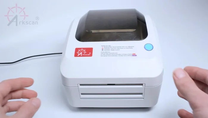 Open the printer cover by pulling and lifting upward on the green side levers.