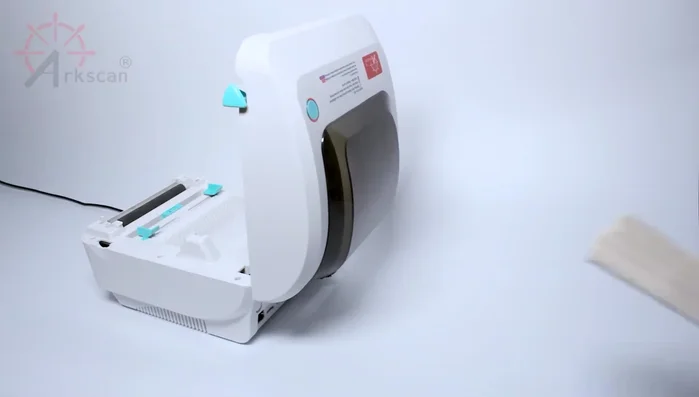Place your labels behind the printer, ensuring the sticker side is up.