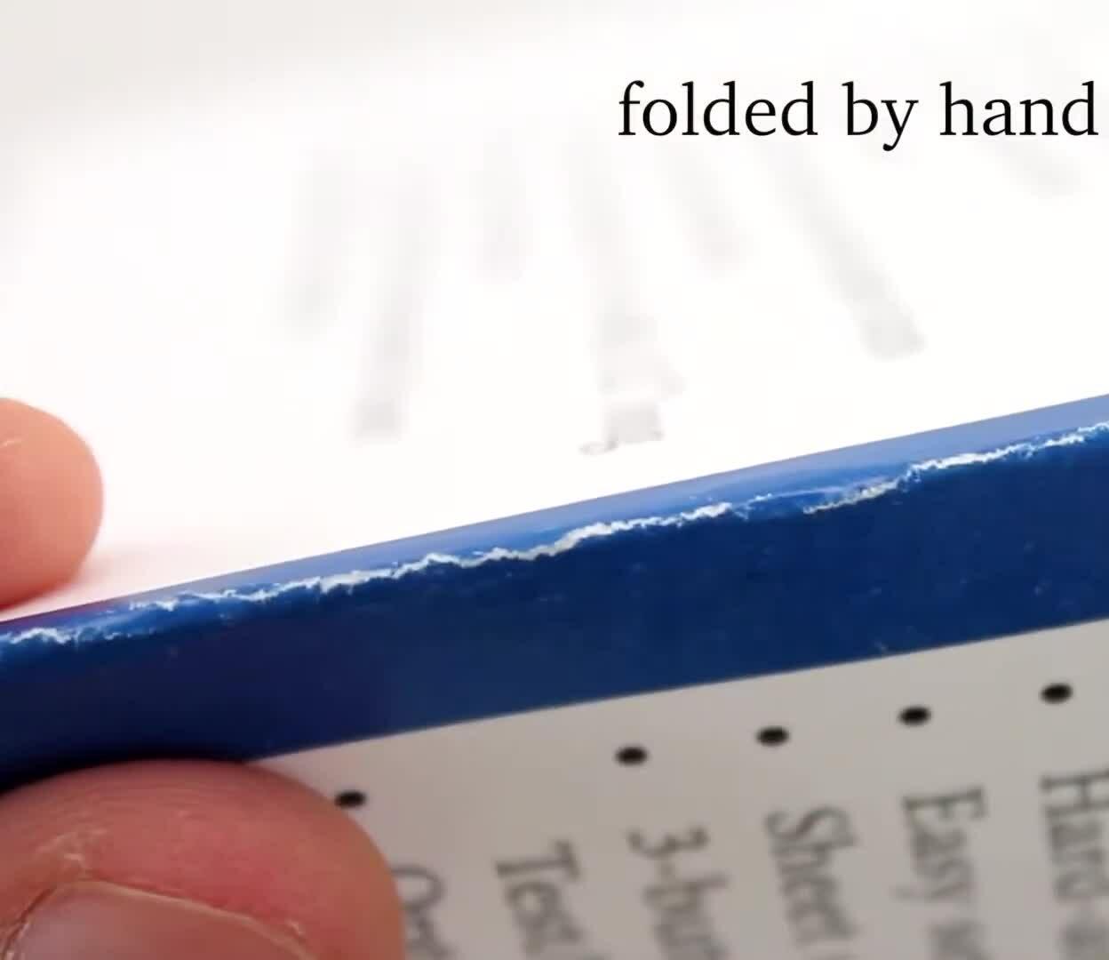 Example of a hand-folded paper showing cracked ink and an uneven fold.