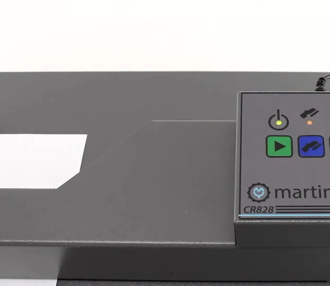 Close-up of the control panel showing the green button.