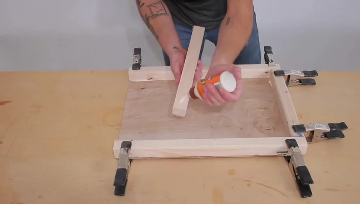 Assemble the crate frame. Apply wood glue and clamp pieces together before nailing. Use 1 ¼ inch finish nails to temporarily hold the pieces while the glue dries.