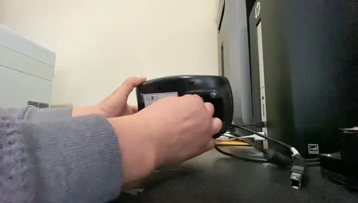 While holding the reset button, plug the power cable back into the printer.