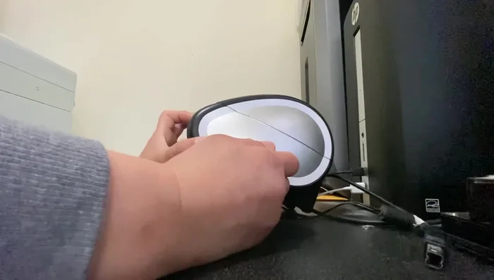 Continue holding the reset button and plug the printer cable back in.