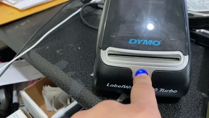 Hold down the reset button (usually blue).