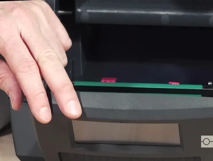 Clean the exit chute/slot in the front control panel, including the flat black plastic part inside, removing any adhesive buildup.