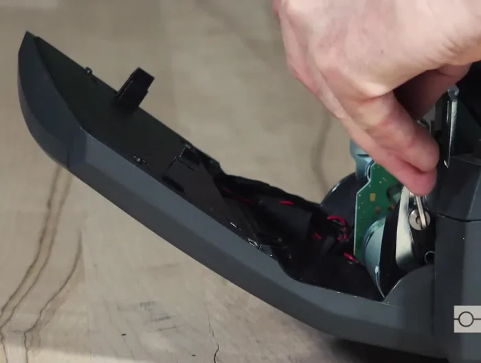 Swing the blade back up and snap the tabs into place. Clean any debris in the cutter's exit chute.