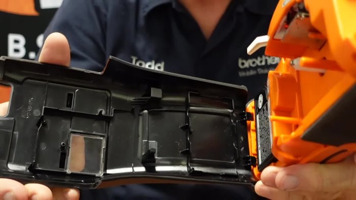 Open the printer's back cover by depressing the latch and pulling outwards.