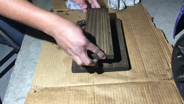 Secure the hooks to the main board using screws.