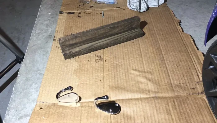 Secure the hooks to the main board using screws.