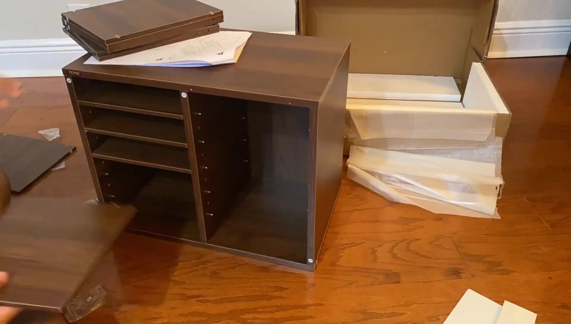 Shot showcasing the organizer filled with various items such as books, papers, and magazines