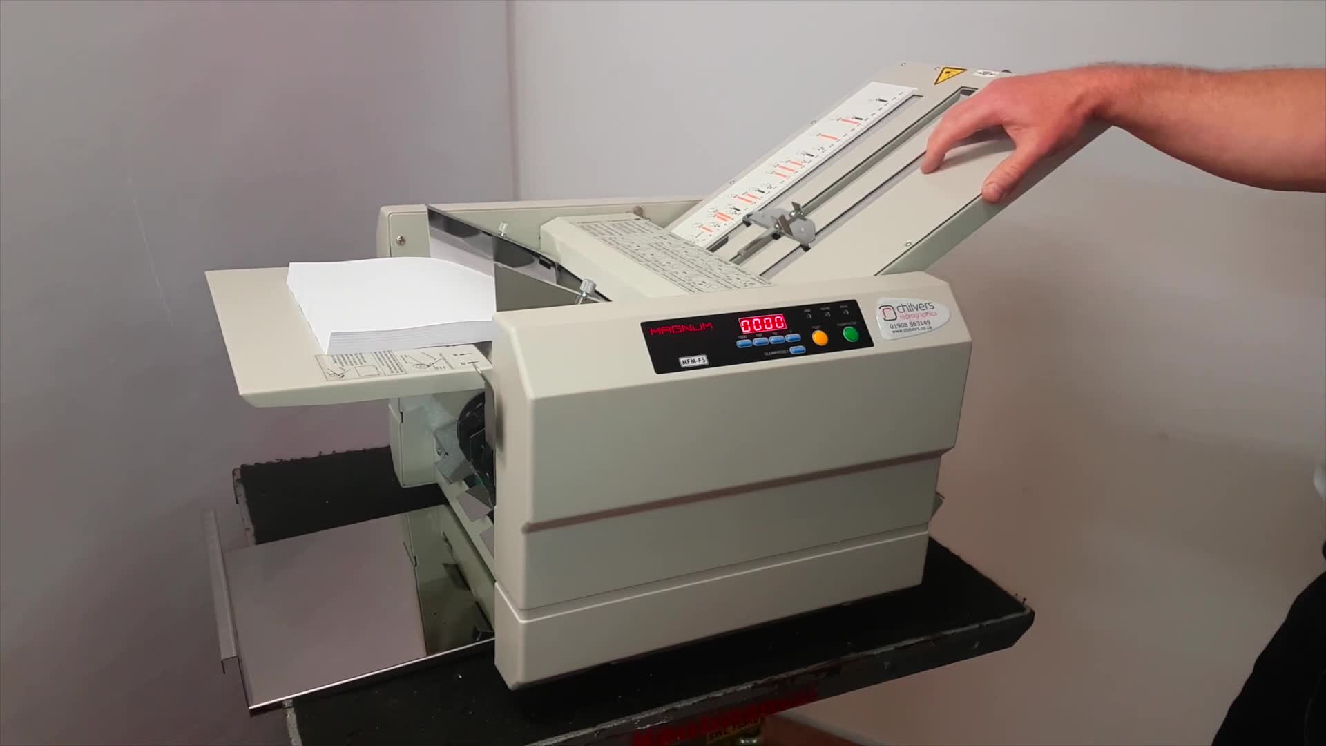 The machine demonstrating folds suitable for mail-outs.