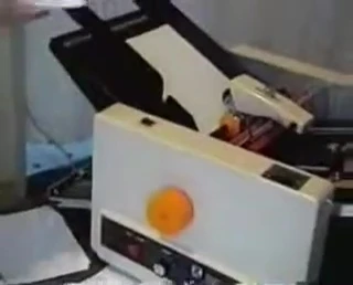 The paper tray with a partial ream of paper.