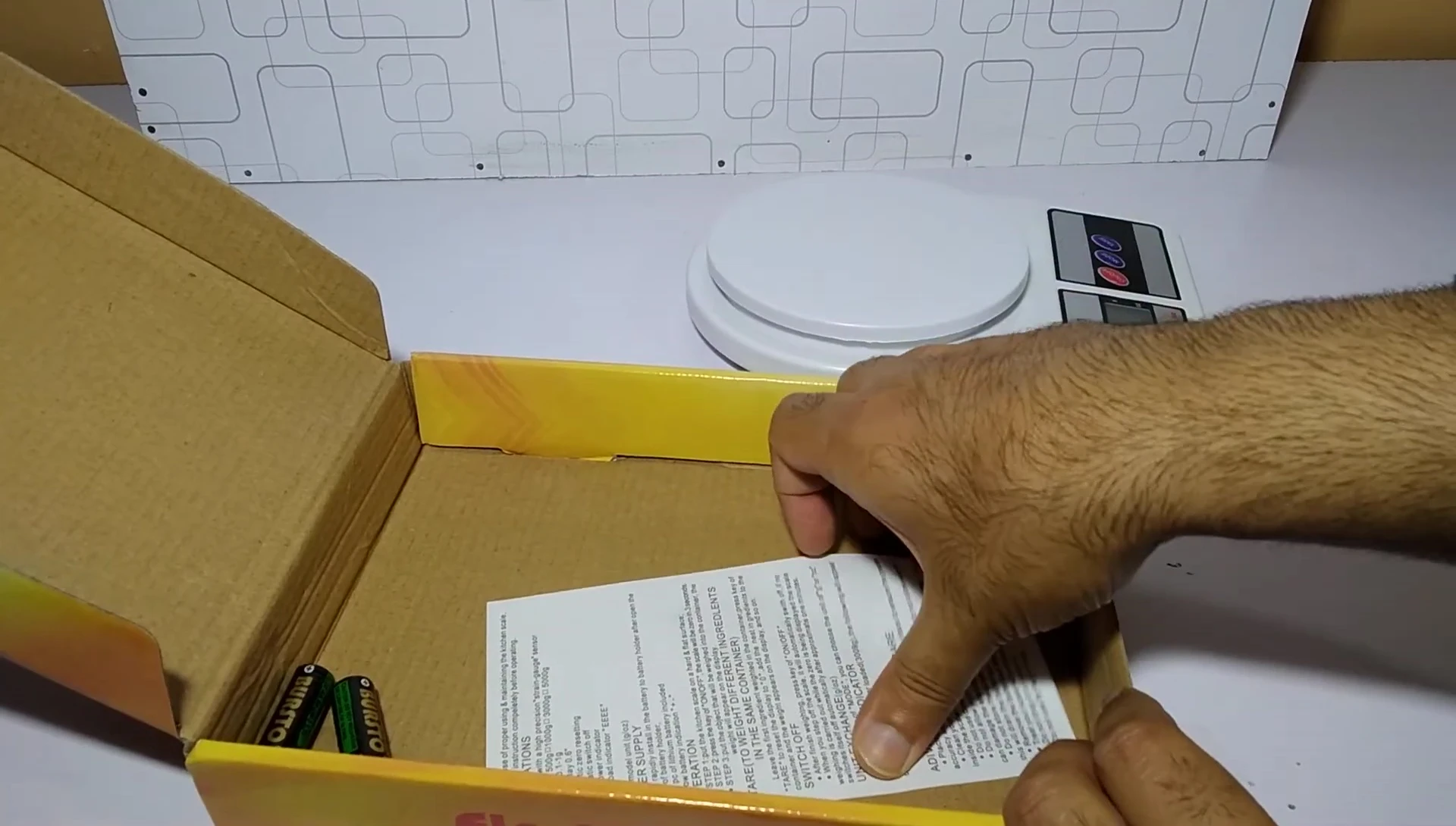 The scale's manual and included batteries