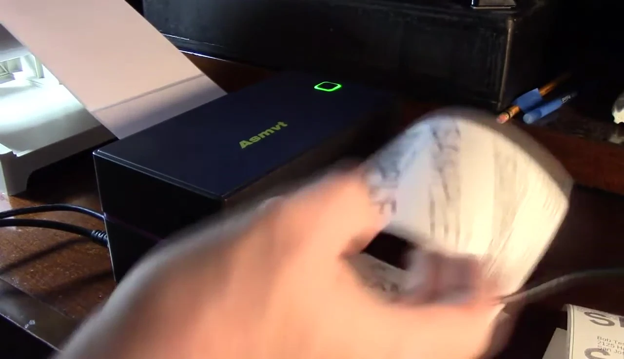 The printed label being removed from the printer