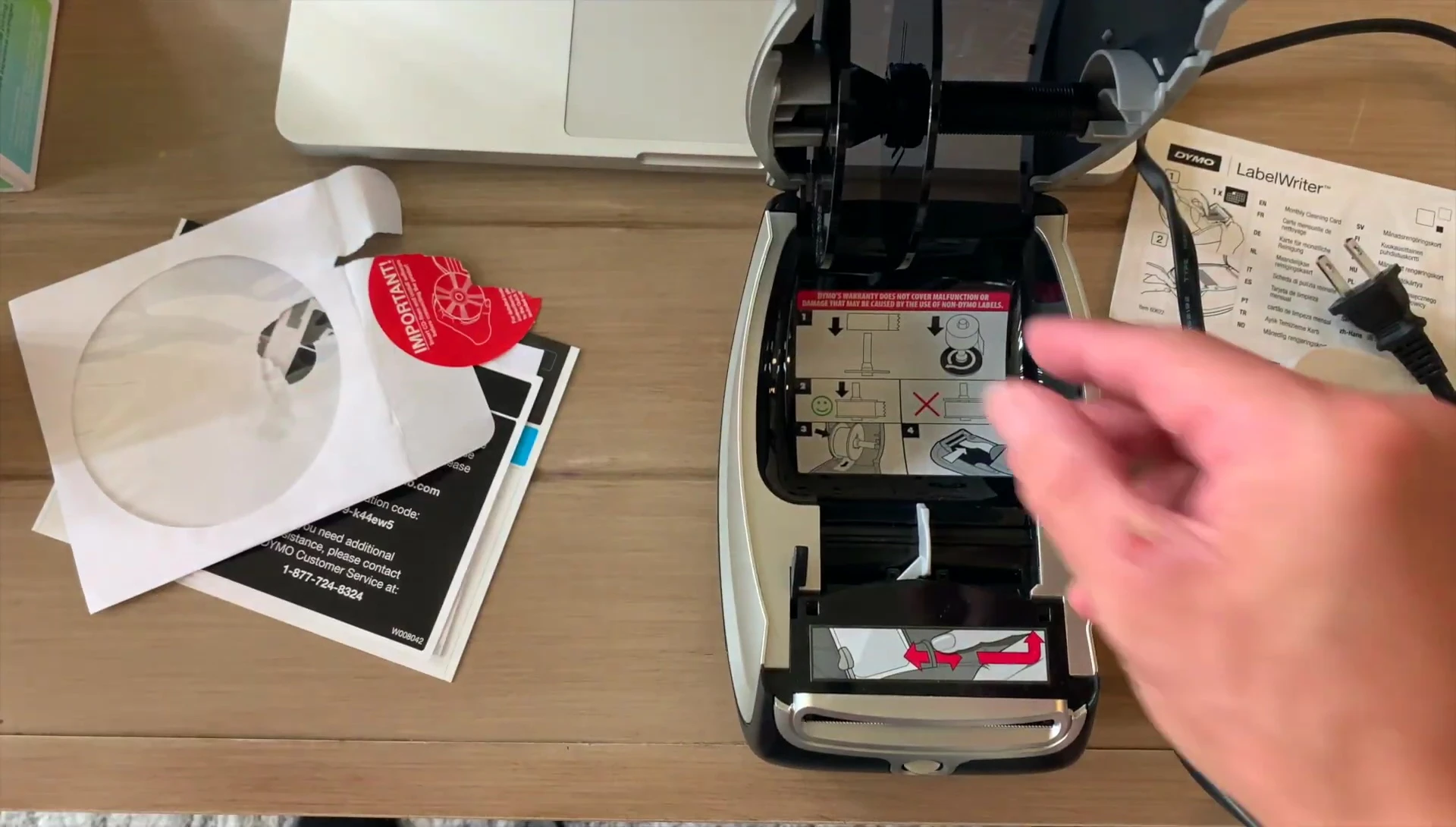 Opening the label spool compartment.