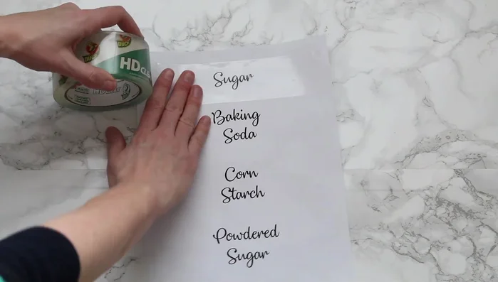 Lay packing tape over the printed labels and smooth it out using a tongue depressor or credit card.