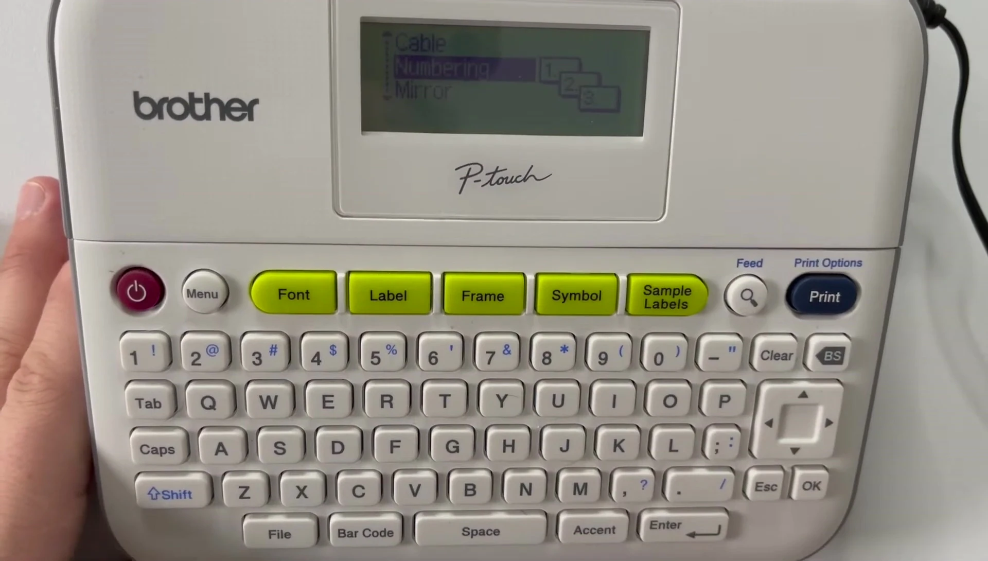Selecting the numbering option on the Brother PT-D400.