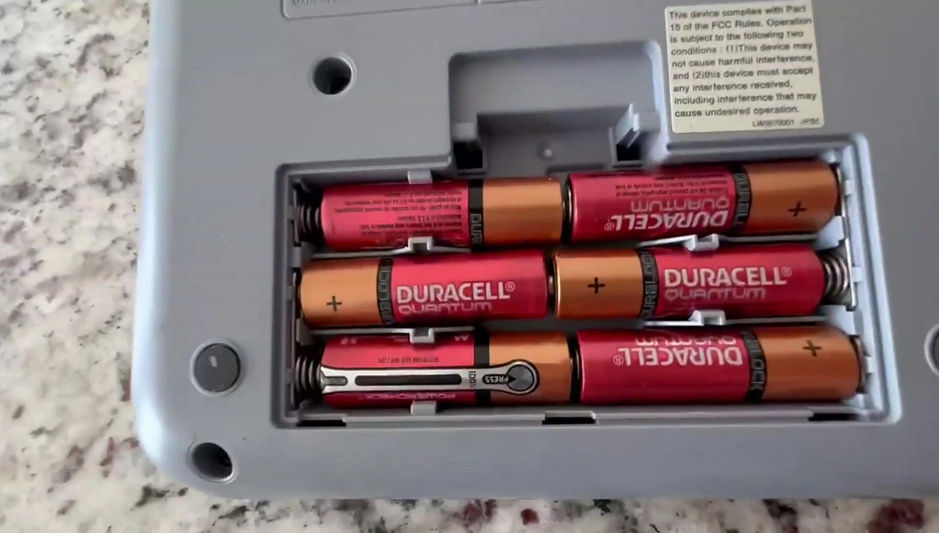 Close-up of the six AA batteries inside the compartment.