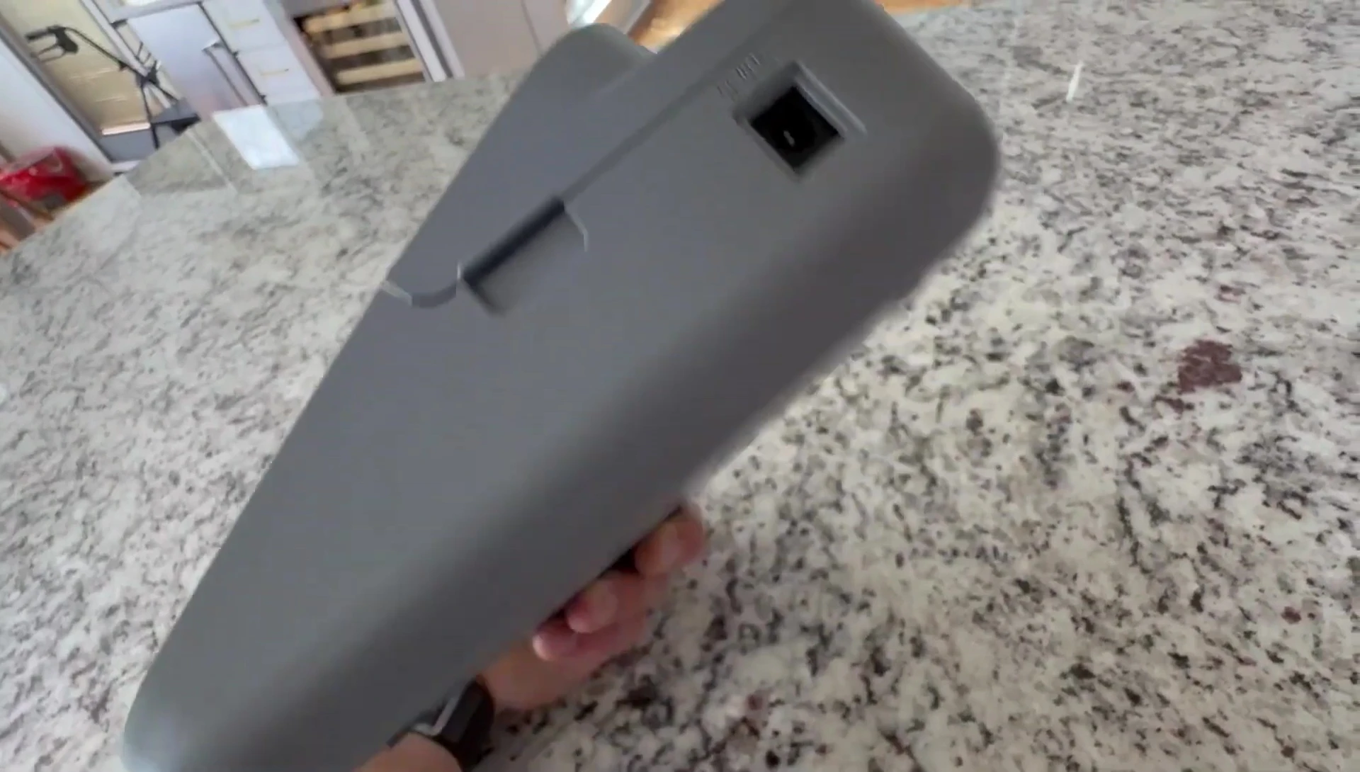 The reviewer showing the battery compartment.