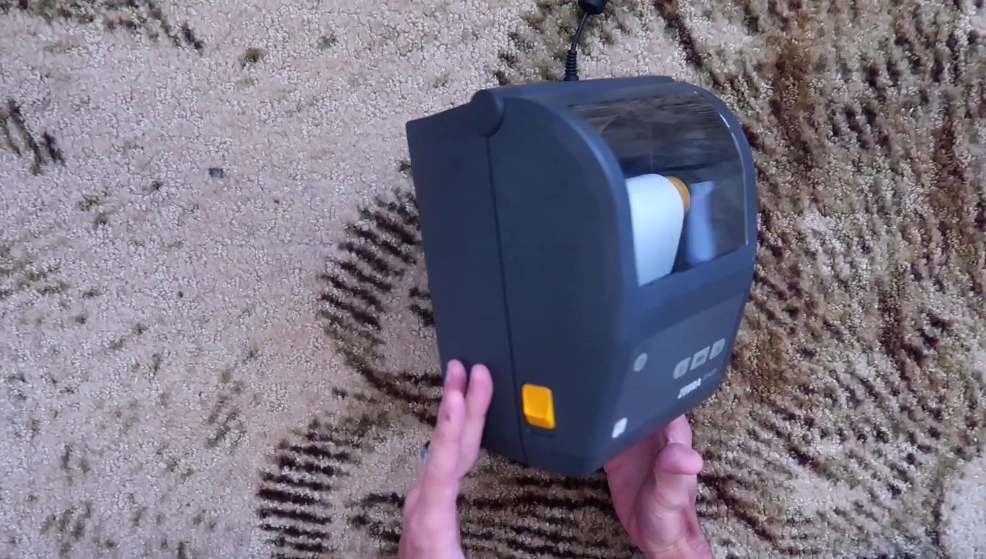 Close-up of the Zebra ZD420 printer showing its matte gray design and yellow accents.