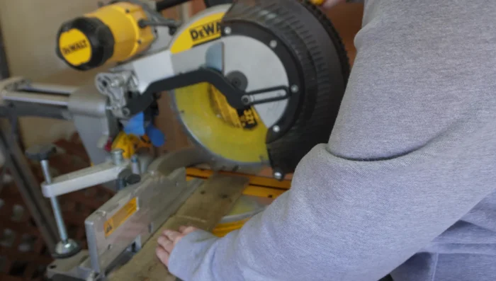 Assemble the mail slot by attaching the angled pieces to the main body with a brad nailer.