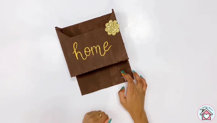 Attach the wall hooks to the bottom of the mailbox using a hot glue gun for key holders.