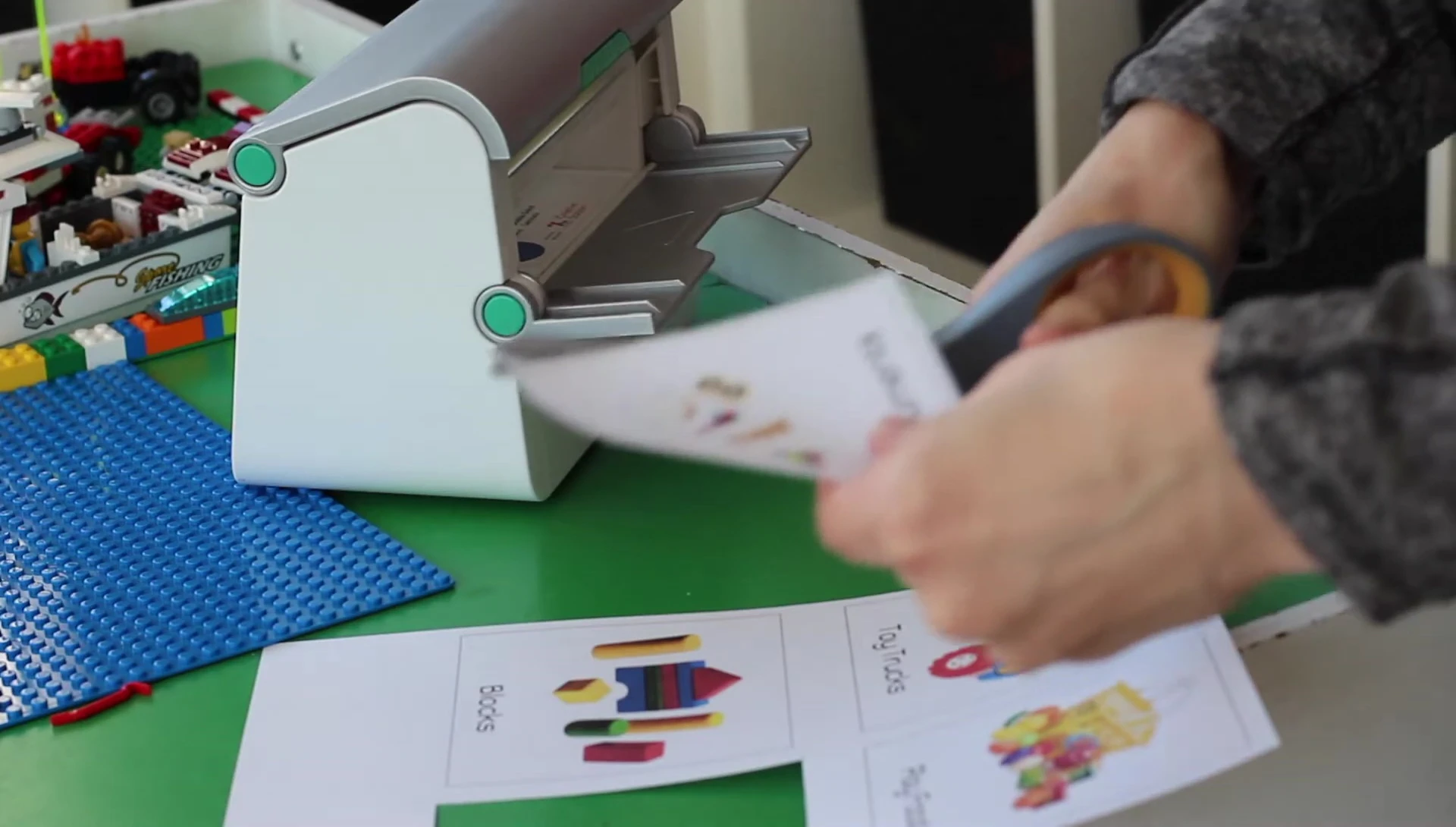 Woman cutting out individual labels.